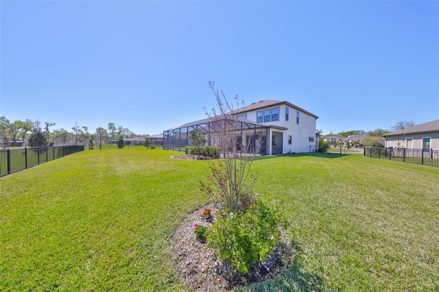 view of yard with a fenced backyard and a lanai