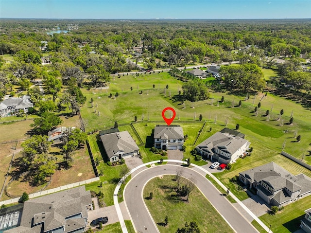 bird's eye view featuring a forest view and a residential view