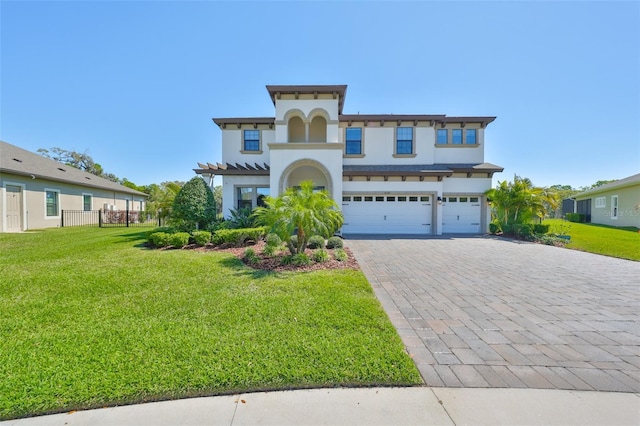 view of front facade featuring decorative driveway, a front lawn, an attached garage, and stucco siding