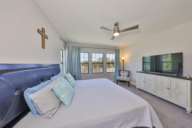 bedroom featuring vaulted ceiling, carpet flooring, baseboards, and ceiling fan