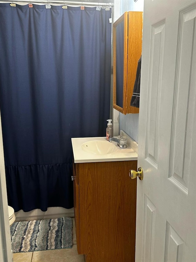 bathroom with vanity, tile patterned floors, and toilet