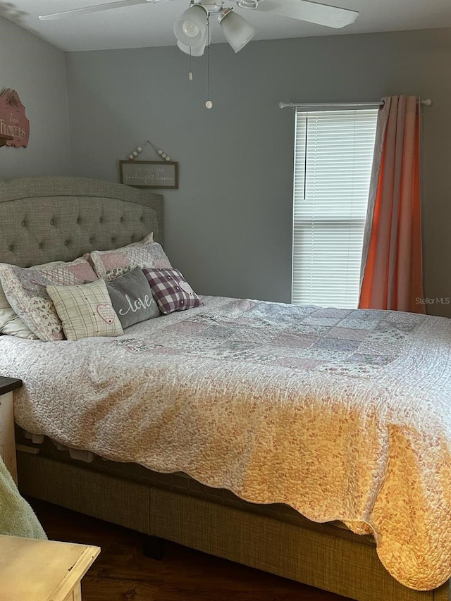 bedroom featuring ceiling fan and wood finished floors