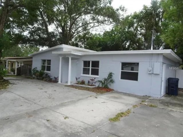 single story home featuring an attached carport and concrete driveway