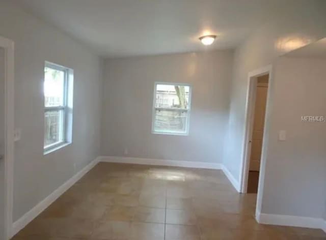 empty room featuring baseboards