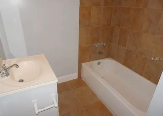 bathroom with vanity, tile patterned floors, and baseboards