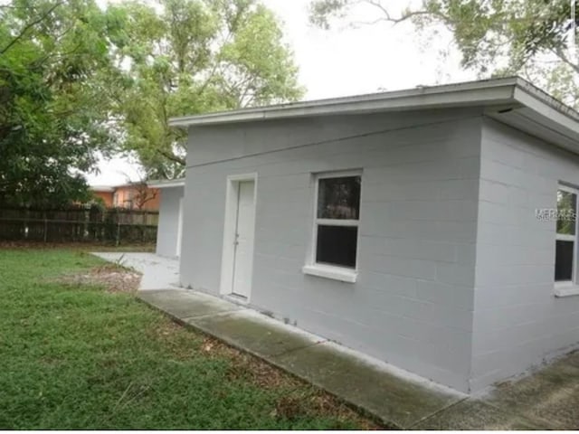 view of home's exterior featuring a yard and fence