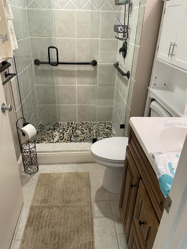 bathroom featuring a stall shower, toilet, and vanity