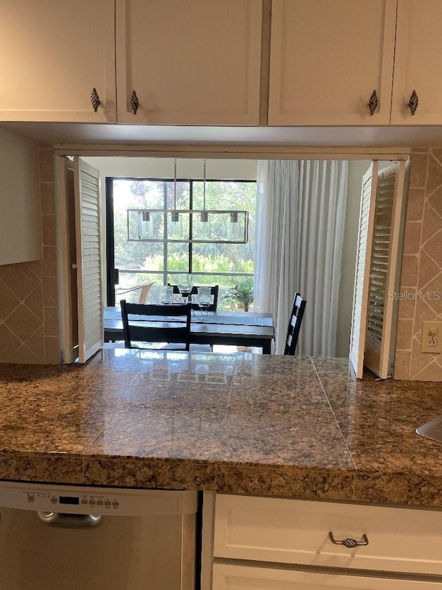 kitchen with tasteful backsplash, tile countertops, dishwasher, and white cabinetry