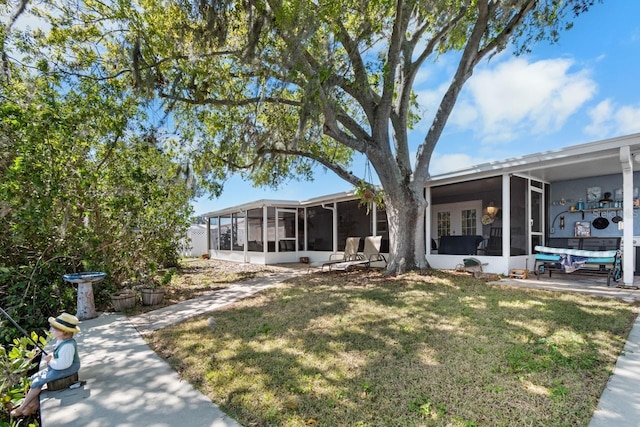 exterior space featuring a lawn and a sunroom