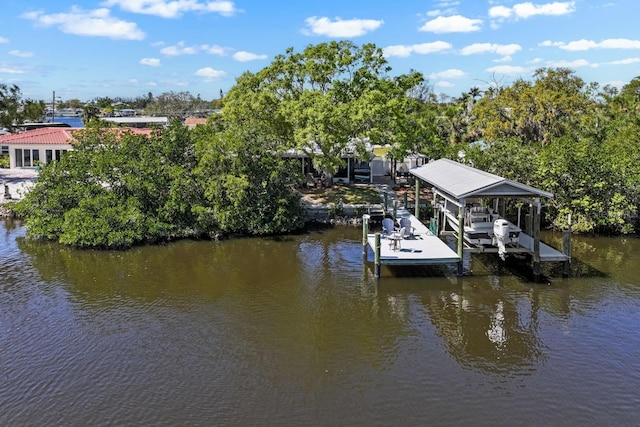 dock area with boat lift and a water view