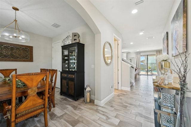 interior space with recessed lighting, arched walkways, visible vents, and baseboards