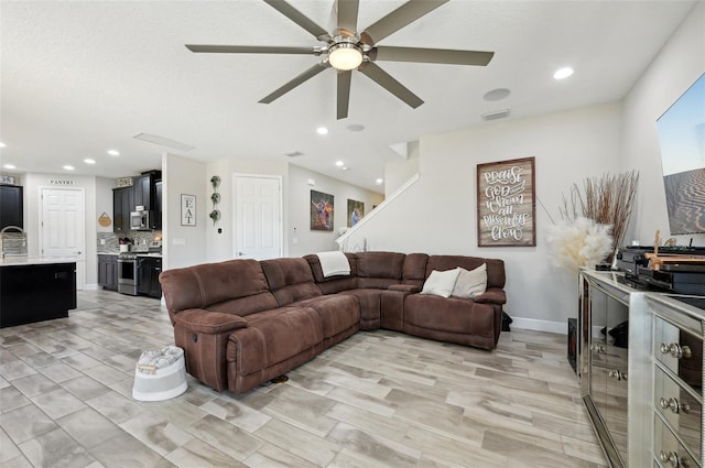 living area featuring recessed lighting, visible vents, baseboards, and a ceiling fan