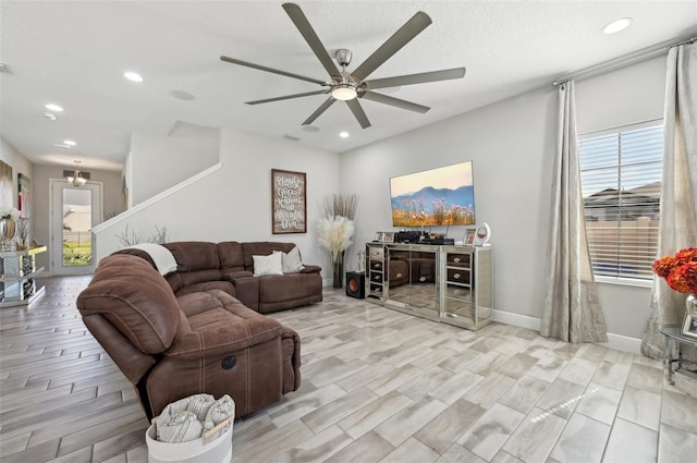 living area featuring recessed lighting, a healthy amount of sunlight, baseboards, and a ceiling fan