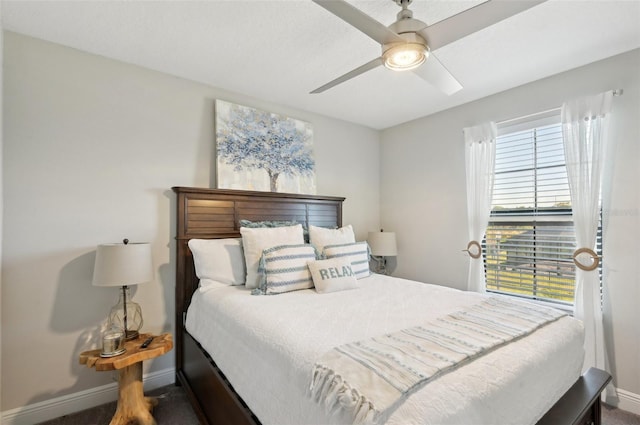 bedroom with a ceiling fan and baseboards