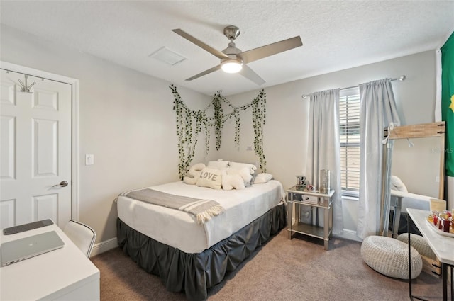 bedroom featuring a ceiling fan, baseboards, a textured ceiling, and carpet flooring