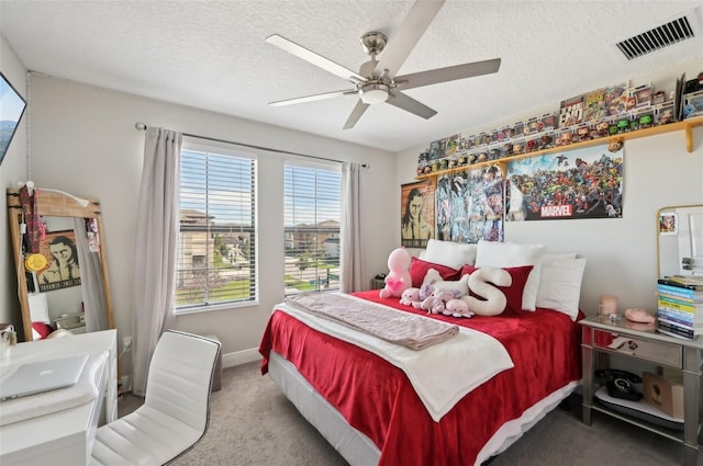 bedroom featuring visible vents, a textured ceiling, carpet, baseboards, and ceiling fan