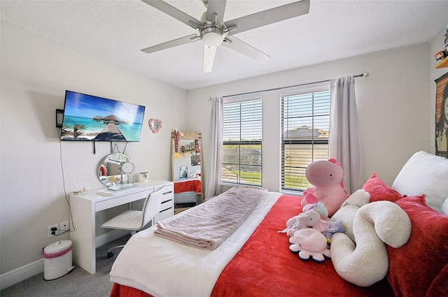 carpeted bedroom featuring a textured ceiling, a ceiling fan, and baseboards