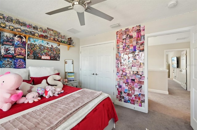 carpeted bedroom featuring visible vents, ceiling fan, baseboards, a closet, and a textured ceiling