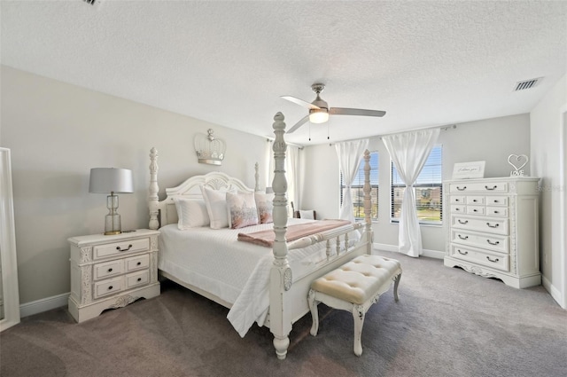 carpeted bedroom featuring a textured ceiling, baseboards, visible vents, and ceiling fan