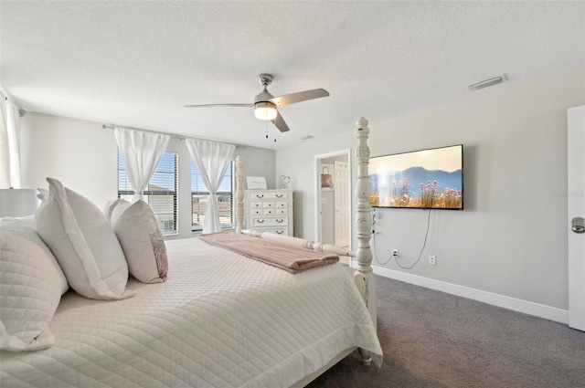 bedroom with a textured ceiling, carpet, visible vents, and baseboards