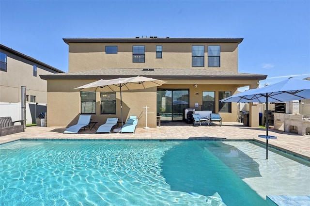 exterior space with a patio, exterior kitchen, and fence