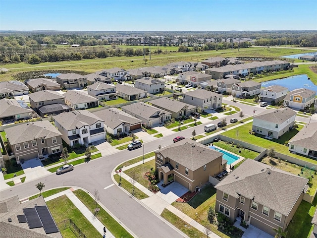 birds eye view of property with a residential view and a water view