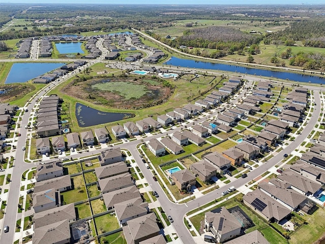 bird's eye view featuring a water view and a residential view