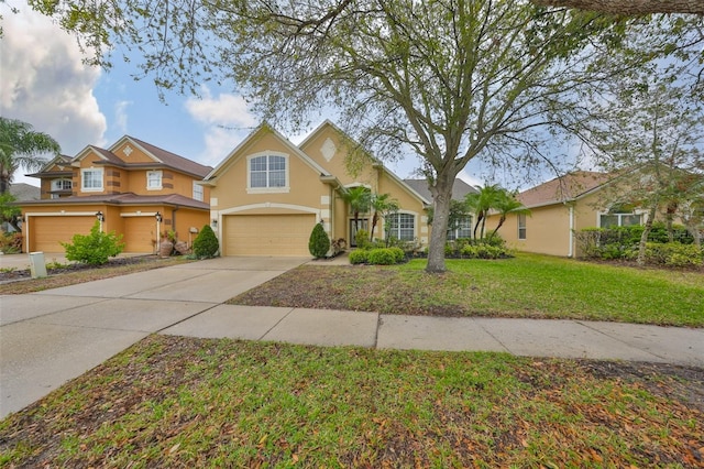 view of front of home with stucco siding, a front lawn, concrete driveway, and an attached garage