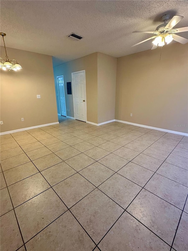 unfurnished room with visible vents, ceiling fan, a textured ceiling, and baseboards