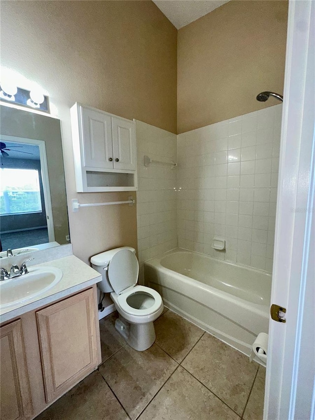 full bath featuring bathing tub / shower combination, toilet, vanity, and tile patterned flooring