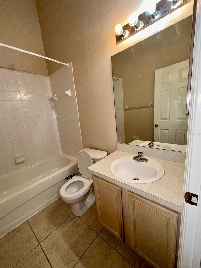 bathroom featuring tile patterned floors, shower / washtub combination, toilet, and vanity