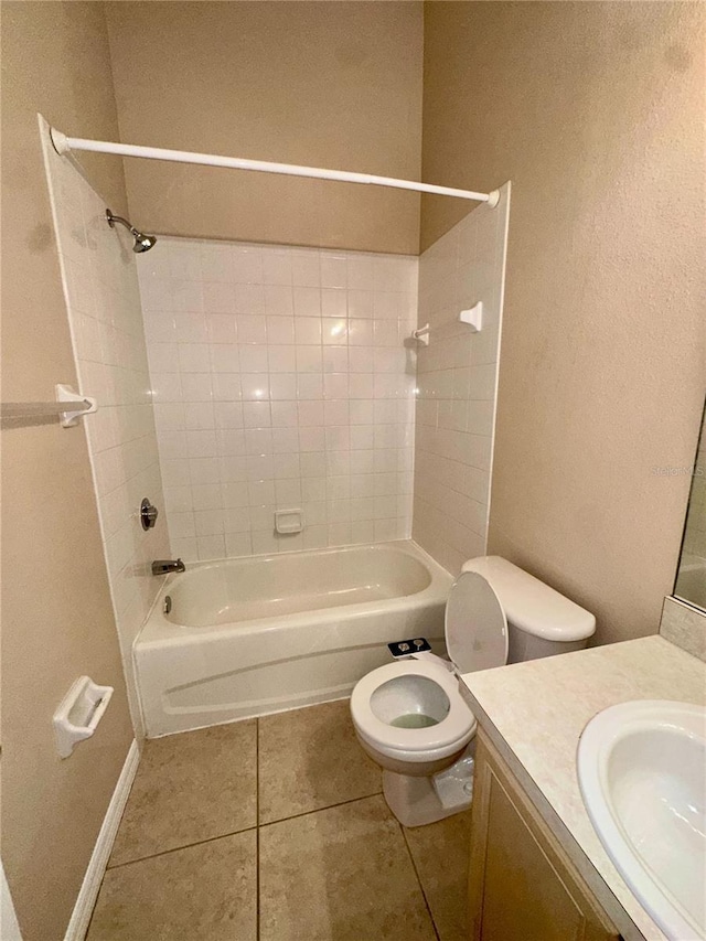 full bathroom featuring toilet, shower / washtub combination, tile patterned flooring, baseboards, and vanity