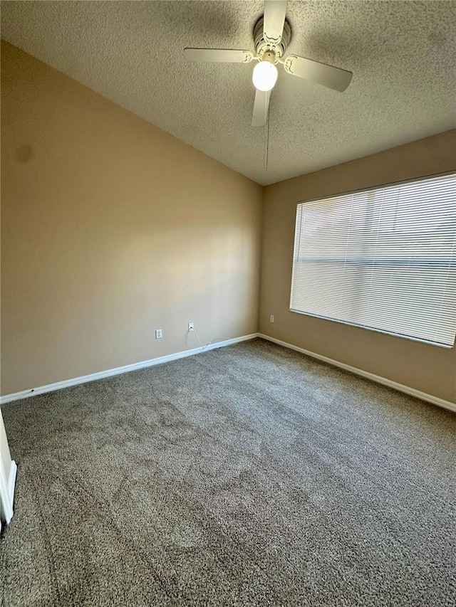 unfurnished room with a textured ceiling, baseboards, carpet, and a ceiling fan