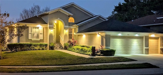 view of front of house with concrete driveway, a garage, and stucco siding