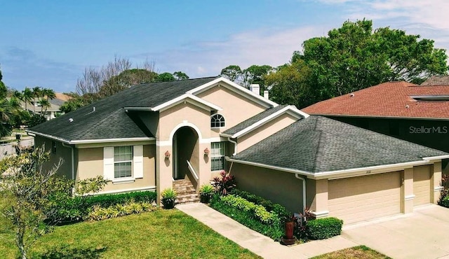 view of front of house with a garage, a shingled roof, driveway, and stucco siding