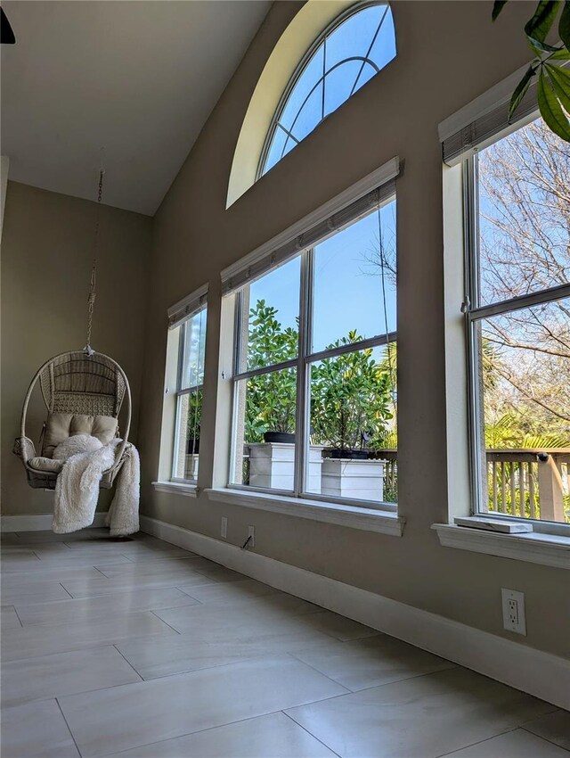 interior space featuring vaulted ceiling and baseboards