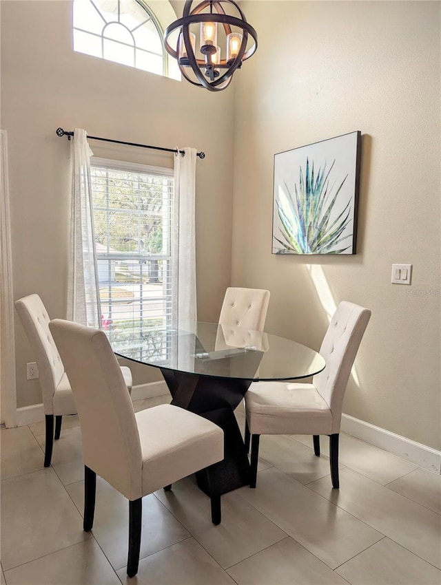 dining room featuring an inviting chandelier and baseboards