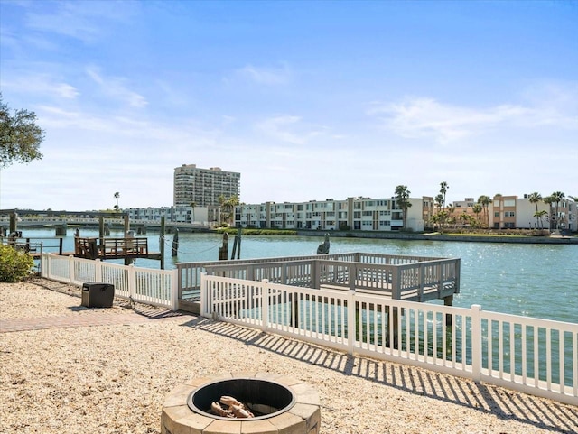 dock area with a water view and a fire pit