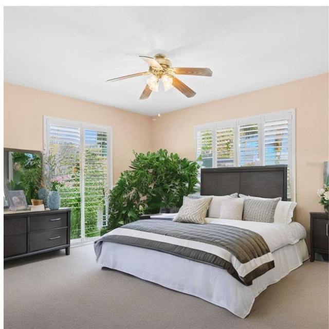 bedroom featuring ceiling fan and carpet