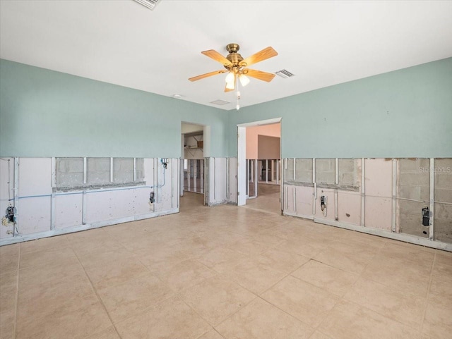 spare room featuring visible vents and a ceiling fan