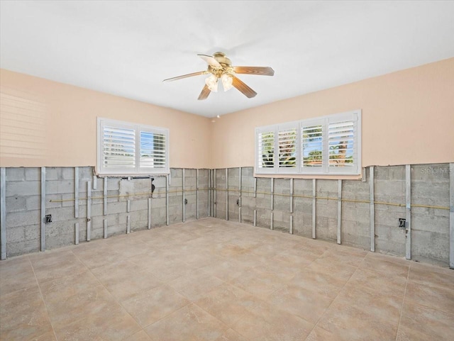 spare room with ceiling fan and a healthy amount of sunlight