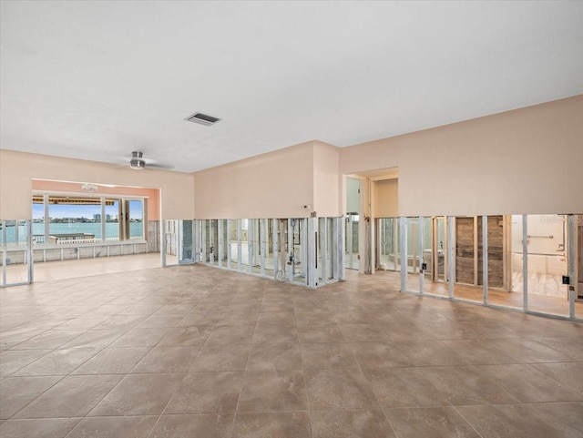 unfurnished room featuring a ceiling fan and visible vents