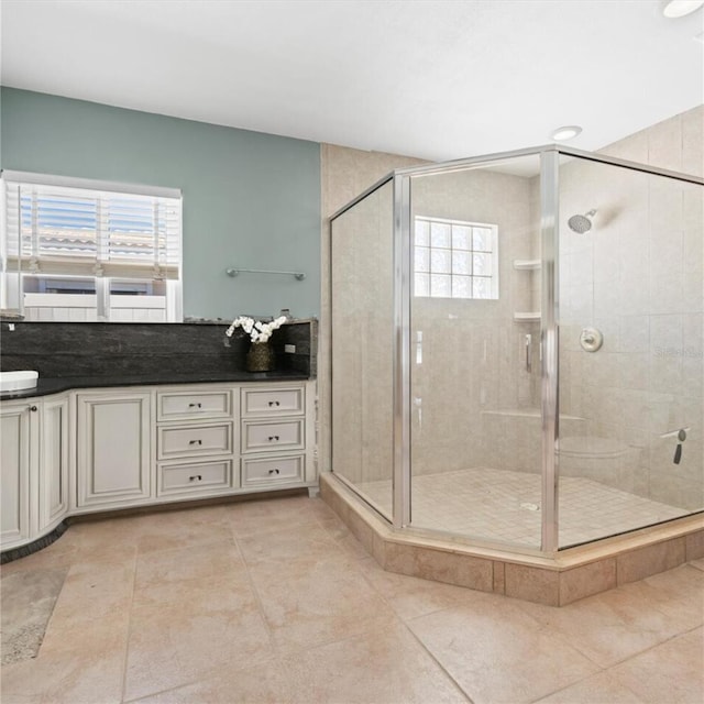 bathroom with vanity, a wealth of natural light, and a shower stall