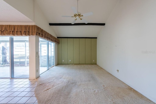 spare room featuring lofted ceiling with beams, light colored carpet, ceiling fan, and light tile patterned floors