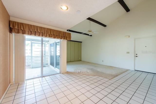 spare room featuring light tile patterned flooring, light colored carpet, ceiling fan, and high vaulted ceiling