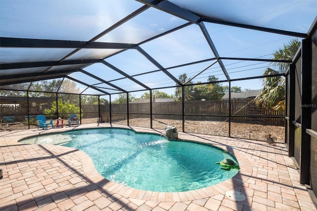 view of pool with glass enclosure, a patio area, a fenced in pool, and a fenced backyard