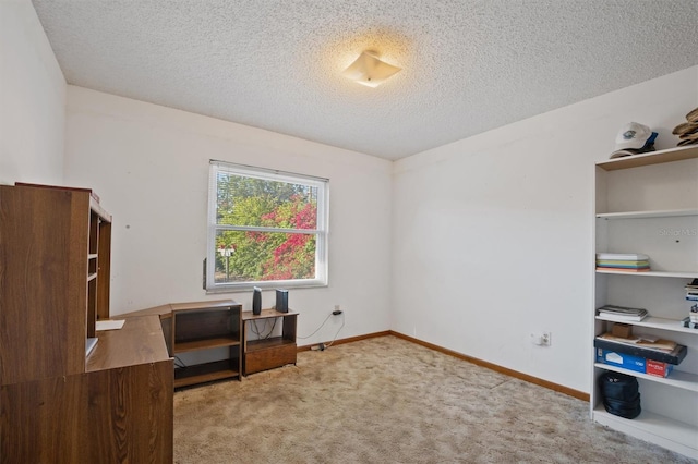 office with baseboards, a textured ceiling, and carpet