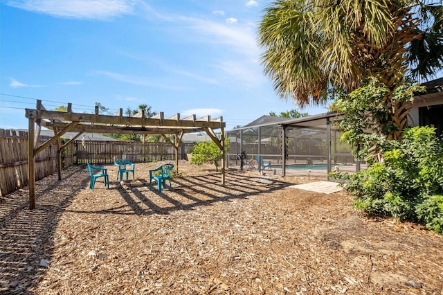 exterior space featuring glass enclosure, a fenced backyard, and a fenced in pool