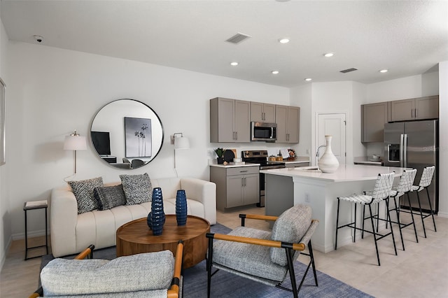 living room featuring visible vents and recessed lighting