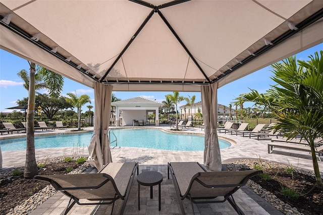 pool featuring a gazebo, a patio, and fence